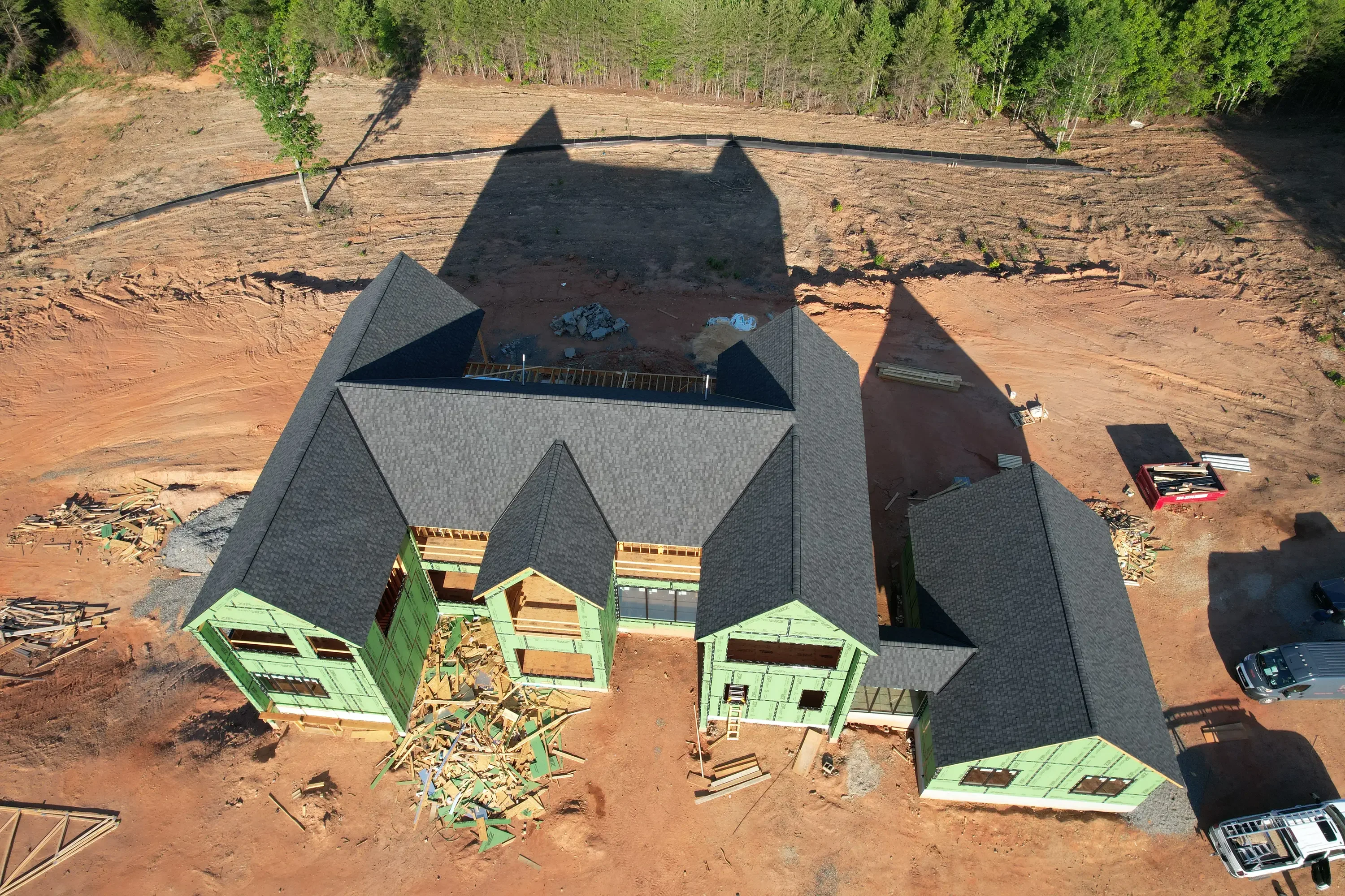 Aerial view of new home construction with gray shingle roof and multiple gables in Shelby, NC